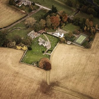 Oblique aerial view centred on the church and manse, taken from the WNW.