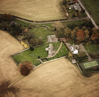 Oblique aerial view centred on the church and manse, taken from the W.