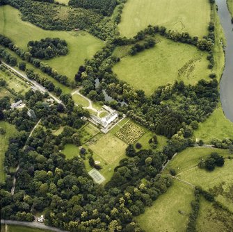 Oblique aerial view centred on the tower-house and country house with the gardens and ancillary buildings adjacent, taken from the ESE.