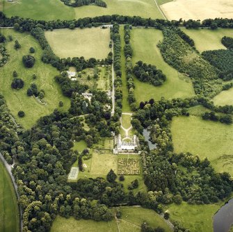 Oblique aerial view centred on the tower-house and country house with the gardens and ancillary buildings adjacent, taken from the ESE.