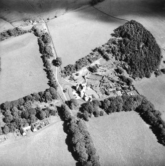Oblique aerial view centred on the country house with the stables adjacent, taken from the WSW.