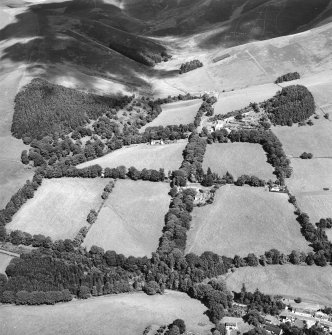 General oblique aerial view looking across the farmsteading towards the country house and stables, taken from the SW.