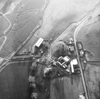 Oblique aerial view centred on tower house from N.