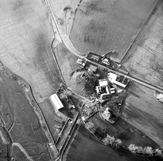 Oblique aerial view centred on tower house from NE.