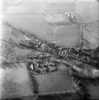 Oblique aerial view centred on village from NE.