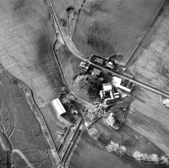 Oblique aerial view centred on tower house from NE.