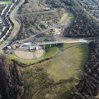 Oblique aerial view centred on the Falkirk Wheel with the remains of the works adjacent, taken from the E.