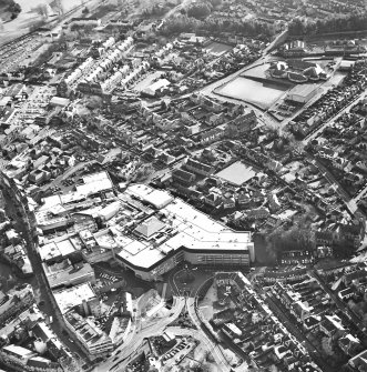 General oblique aerial view of the shopping centre and church, taken from the NW.