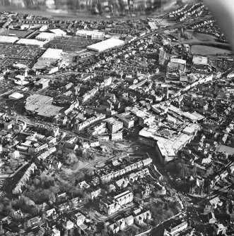 General oblique aerial view of the shopping centre and church, taken from the W.