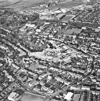 General oblique aerial view of the shopping centre and church, taken from the SSE.