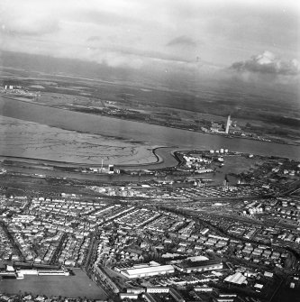 General oblique aerial view looking across the docks towards Fife, taken from the SE.