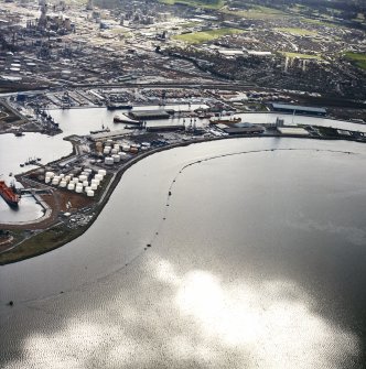Oblique aerial view centred on the docks with the oil refinery and town adjacent, taken from the NNW.