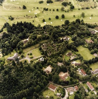 Oblique aerial view centred on the remains of the country house, taken from the NE.