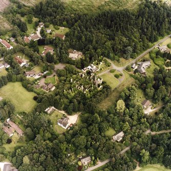 Oblique aerial view centred on the remains of the country house, taken from the WSW.