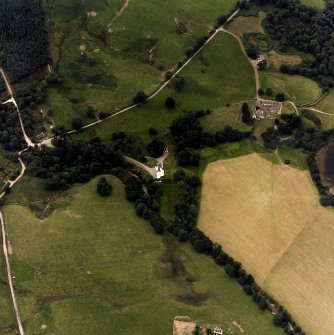 Oblique aerial view centred on the castle with farmstead adjacent, taken from the ENE.