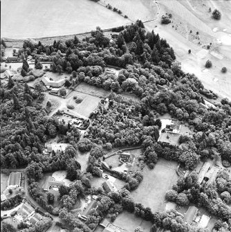 Oblique aerial view centred on the remains of the country house, taken from the NNW.