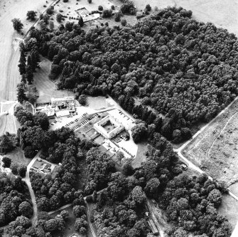 Oblique aerial view centred on the stable with club house and country house adjacent, taken from the E.