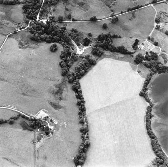 Oblique aerial view centred on the castle with farmstead adjacent, taken from the NE.