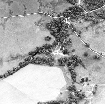 Oblique aerial view centred on the castle with farmstead adjacent, taken from the NNW.