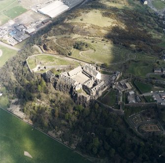 Oblique aerial view centred on the castle with the cemetery adjacent, taken from the SSW.