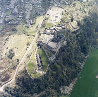 Oblique aerial view centred on the castle with the cemetery and burial-ground adjacent, taken from the NW.