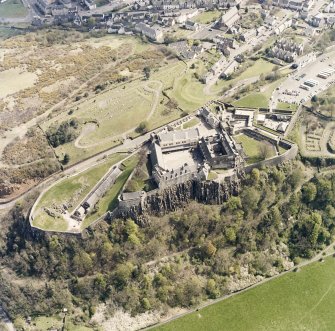 Oblique aerial view centred on the castle with the cemetery adjacent, taken from the W.
