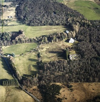 Oblique aerial view centred on the country house with garage block, walled garden and lodge adjacent, taken from the WSW.