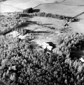 Oblique aerial view centred on the country house with walled garden and lodge adjacent, taken from the SE.