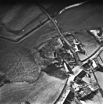 Dalton, oblique aerial view, taken from the ENE, centred on the old parish church and the parish church.  A road bridge is visible in the centre top half of the photograph.