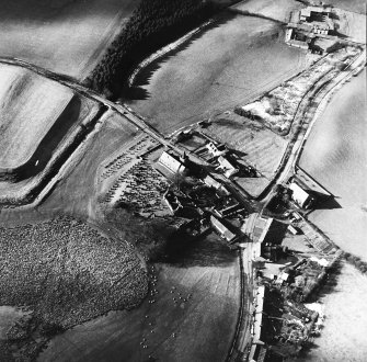 Dalton, oblique aerial view, taken from the ESE, centred on the old parish church and the parish church.  A road bridge is visible in the top left hand corner of the photograph.