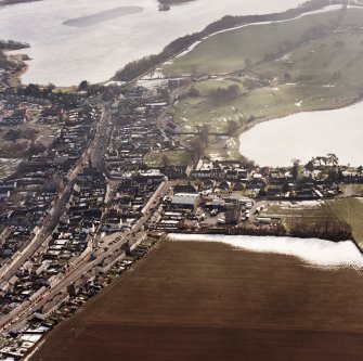 Lochmaben, oblique aerial view, taken from the NW, centred on the S part of the town, with St Mary Magdalene's church and burial ground and Lochmaben old castle and motte visible in the centre of the photograph.