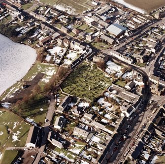 St Mary Magdalene's Church, oblique aerial view, taken from the SE, centred on the churchyard.  Lochmaben Town hall is visible in the centre right hand of the photograph.