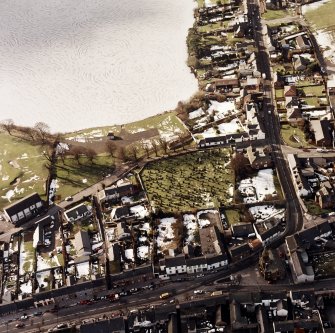 St Mary Magdalene's Church, oblique aerial view, taken from the ENE, centred on the churchyard.  Lochmaben Town Hall is visible in the bottom right-hand corner of the photograph.