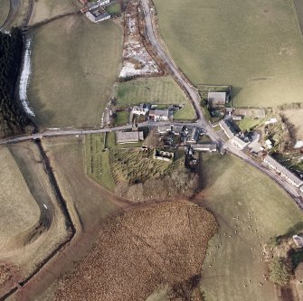 Dalton, oblique aerial view, taken from the SE, centred on the old parish church and the parish church.  A road bridge is visible in the centre left half of the photograph.