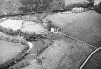 Oblique aerial view centred on tower house from SW.