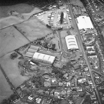 Oblique aerial view from NNE, centred on two L type hangars and the site of a third.