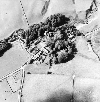 Oblique aerial view from S of village with parish church in the centre.