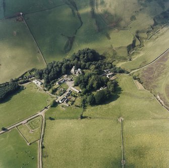 Oblique aerial view from SE of village with the parish church in the centre.