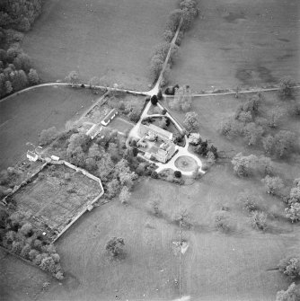 Oblique aerial view centred on the tower-house, stables and outbuildings, taken from the ESE.