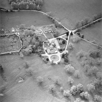 Oblique aerial view centred on the tower-house, stables and outbuildings, taken from the E.