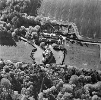 Oblique aerial view centred on the country house and stables, taken from the ESE.