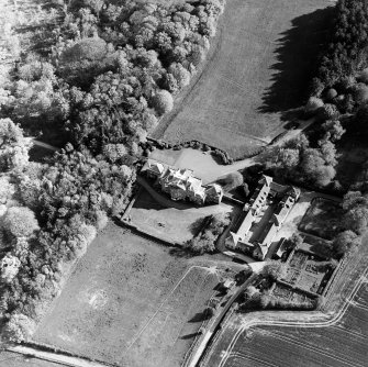 Oblique aerial view centred on the country house and stables, taken from the NNE.