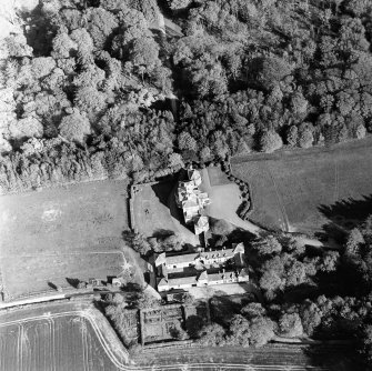 Oblique aerial view centred on the country house and stables, taken from the NW.