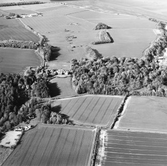 General oblique aerial view looking over cottage, country house, stables and gardens towards Tallowquhairn, taken from the SSW.