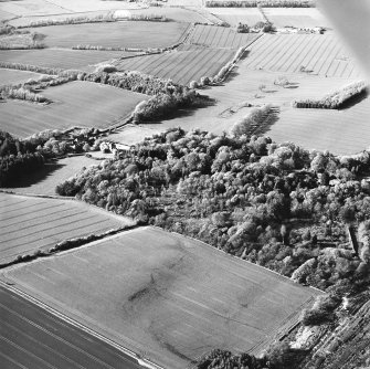 Oblique aerial view centred on the country house, stables, gardens and walled garden, taken from the SSE.