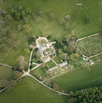 Oblique aerial view centred on the tower-house, stables and outbuildings, taken from the WNW.