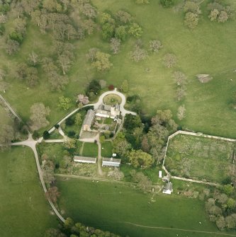 Oblique aerial view centred on the tower-house, stables and outbuildings, taken from the WSW.