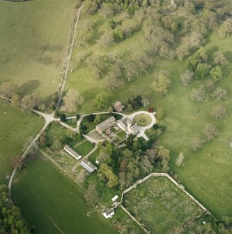 Oblique aerial view centred on the tower-house, stables and outbuildings, taken from the SW.
