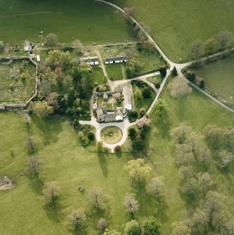 Oblique aerial view centred on the tower-house, stables and outbuildings, taken from the E.