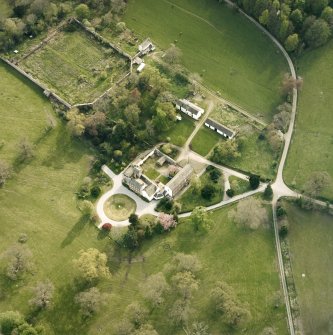 Oblique aerial view centred on the tower-house, stables and outbuildings, taken from the NE.